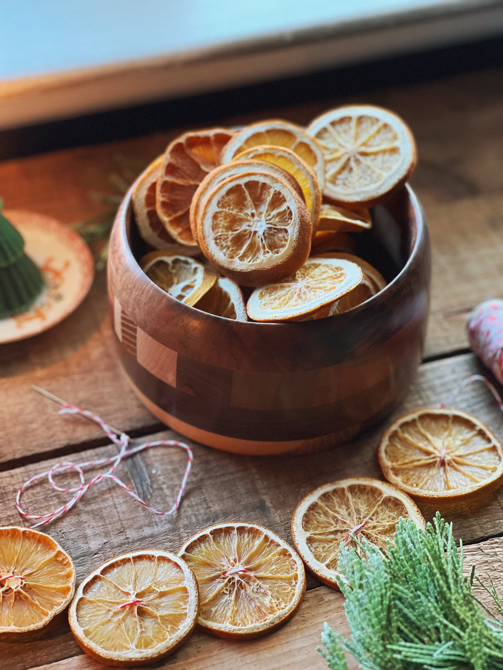 wood bowl filled with dried orange slices