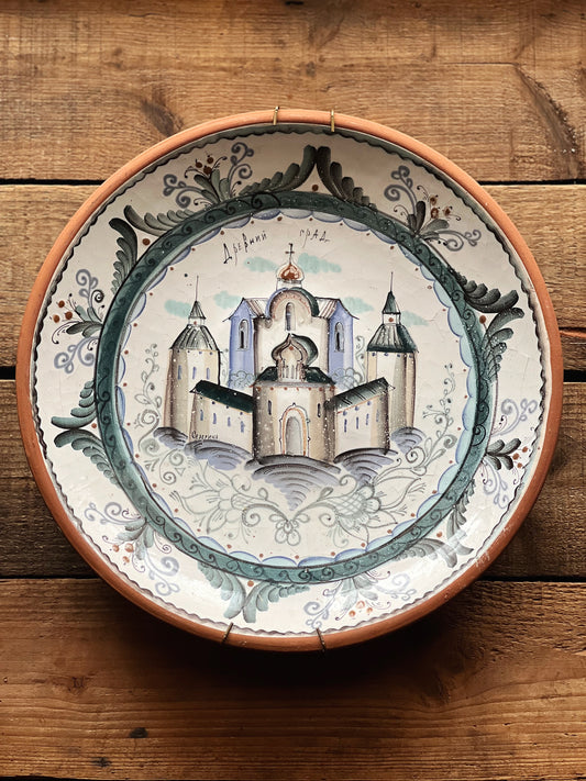 hand painted decorative wall plate featuring a castle