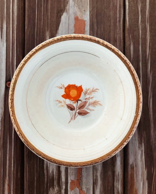 Vintage plate with a floral design on a wooden background