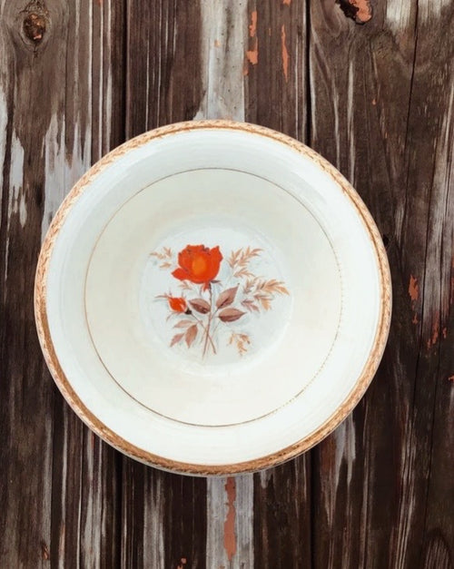Vintage plate with floral design on a wooden surface