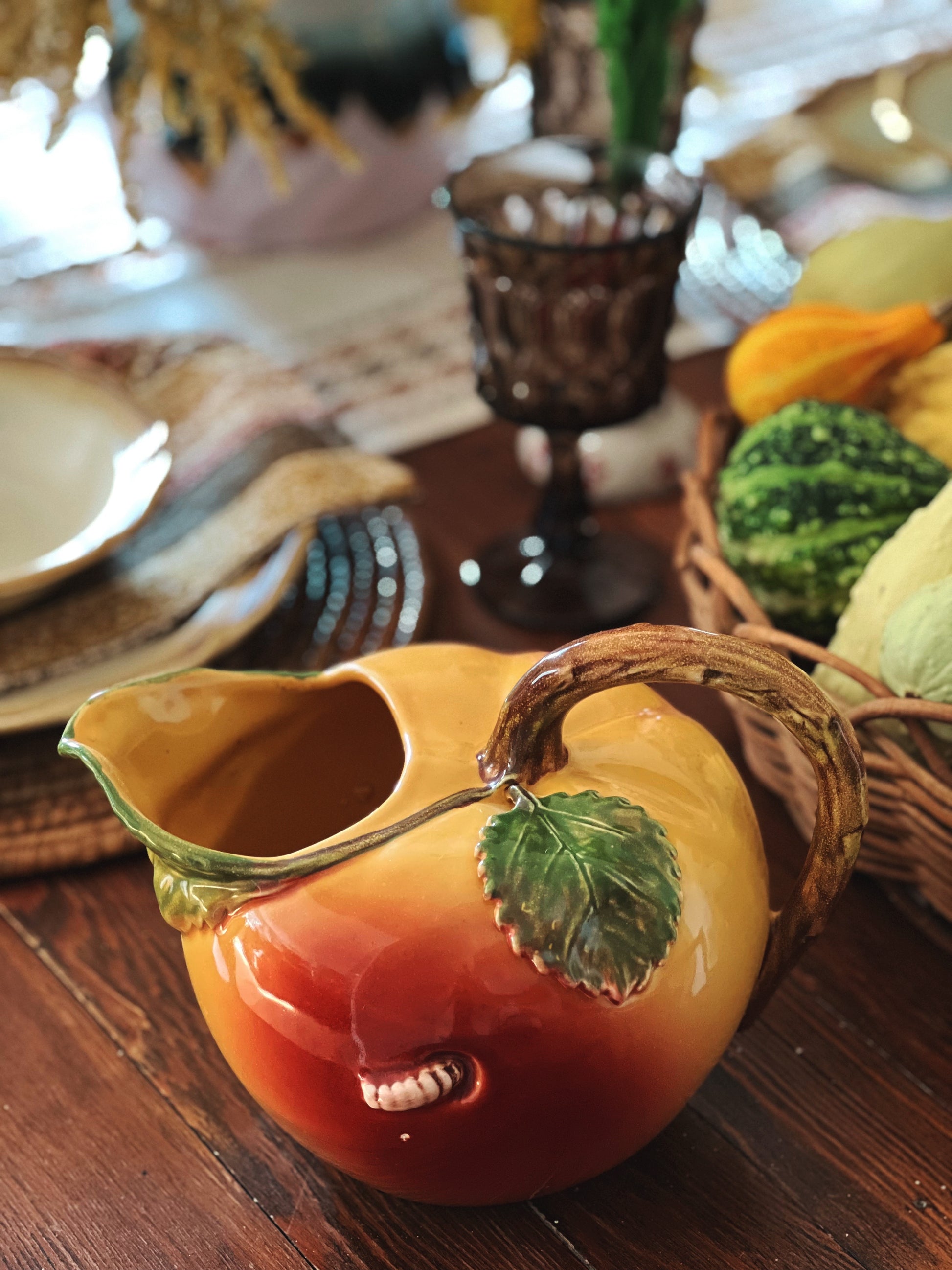 Decorative ceramic pumpkin on a wooden table with a blurred background