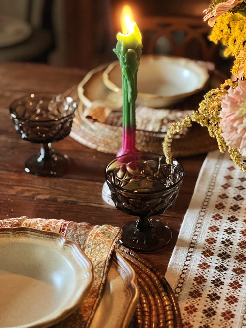 brown champagne coupes on a table set for dinner