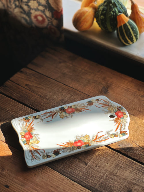 small ceramic cutting board on a wood surface
