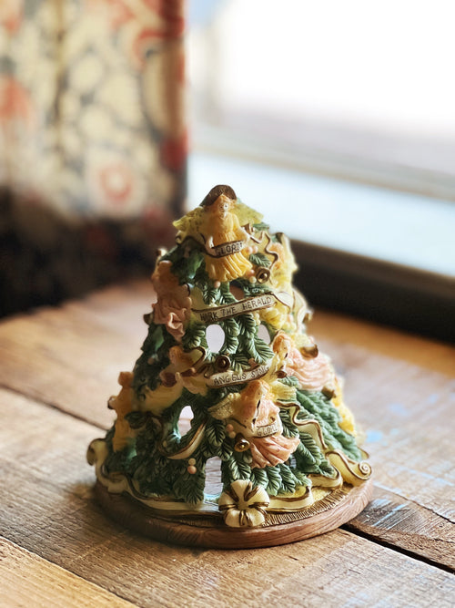 Decorative Christmas tree figurine with rings on a wooden surface