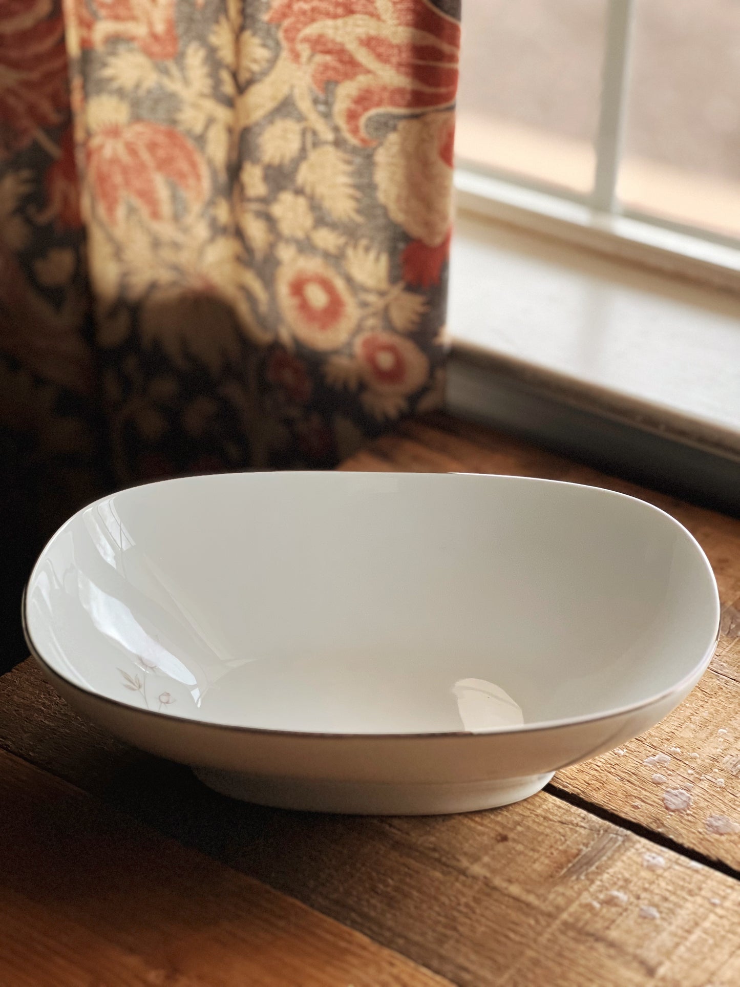 white oval serving bowl with a pink rose and platinum trim