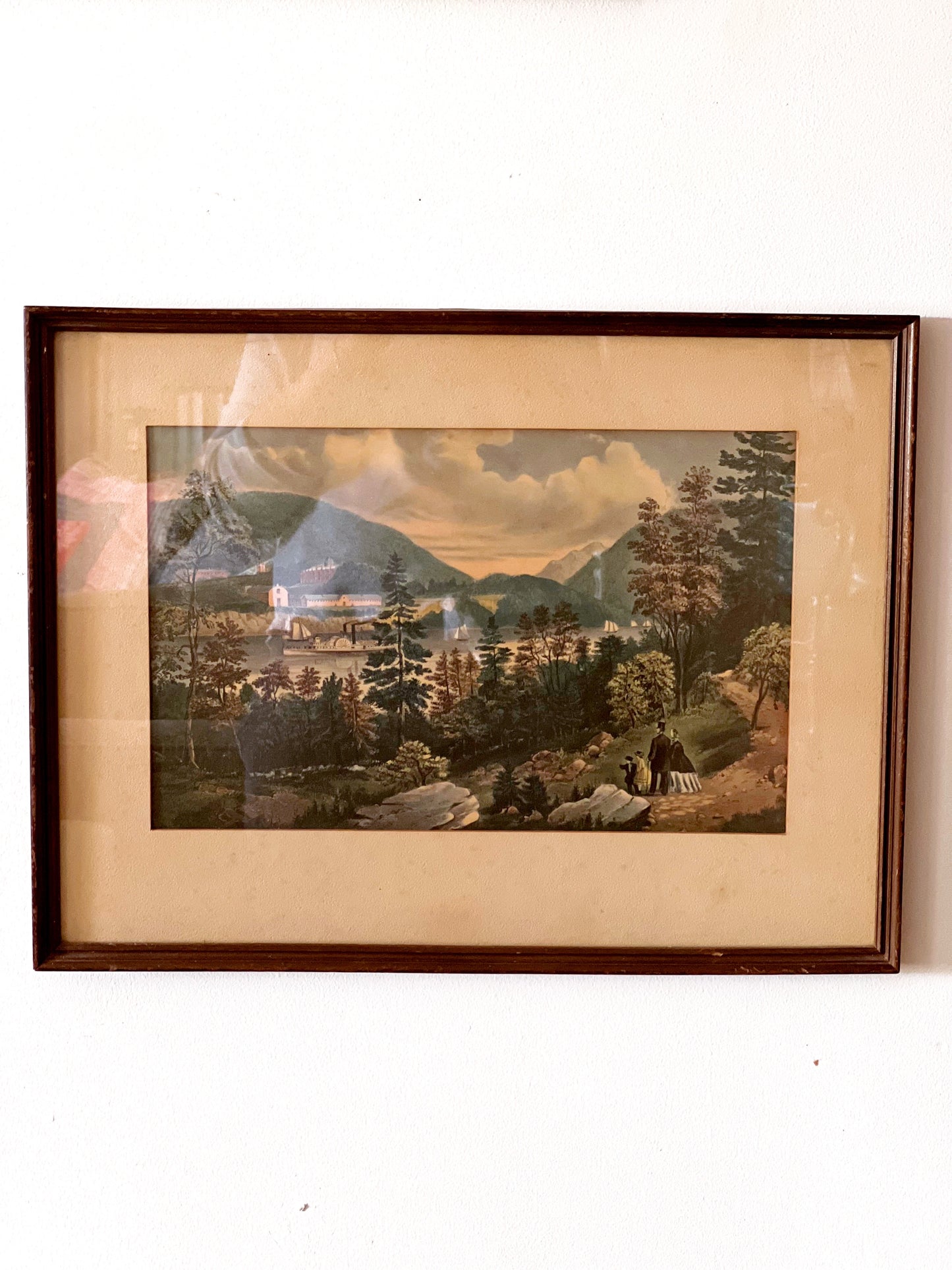 vintage landscape print in a brown frame with a taupe matte