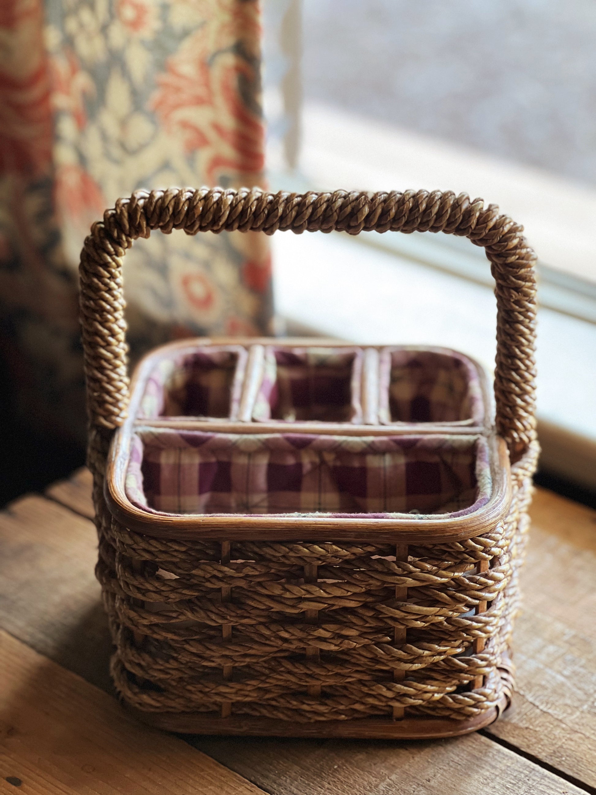Woven basket with a plaid interior on a wooden surface