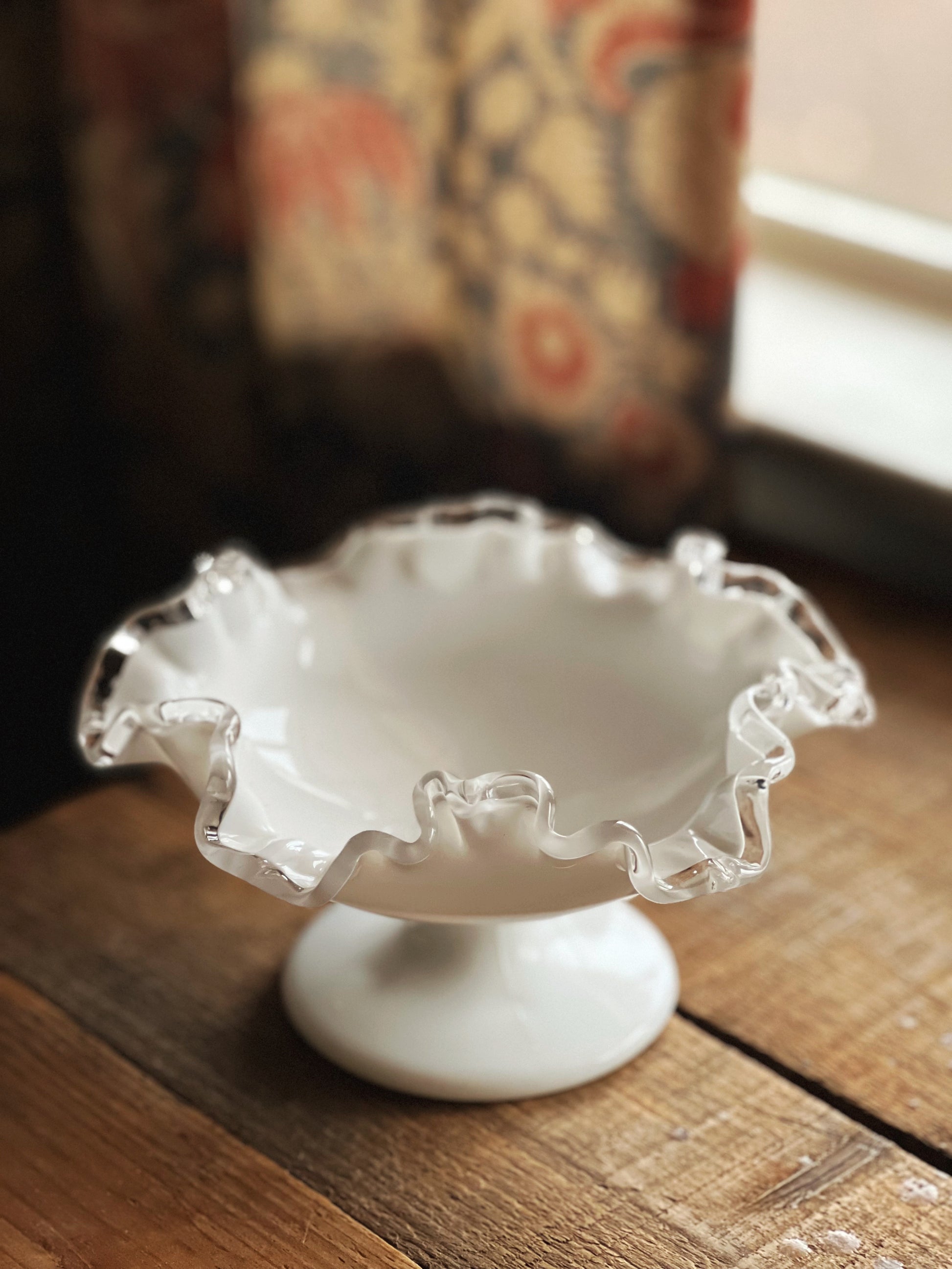 white milk glass bowl with a clear glass rim