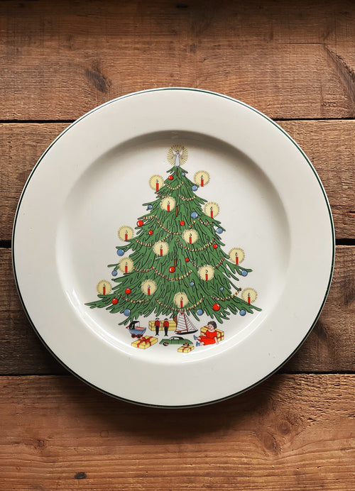 Decorative plate with a Christmas tree design on a wooden surface
