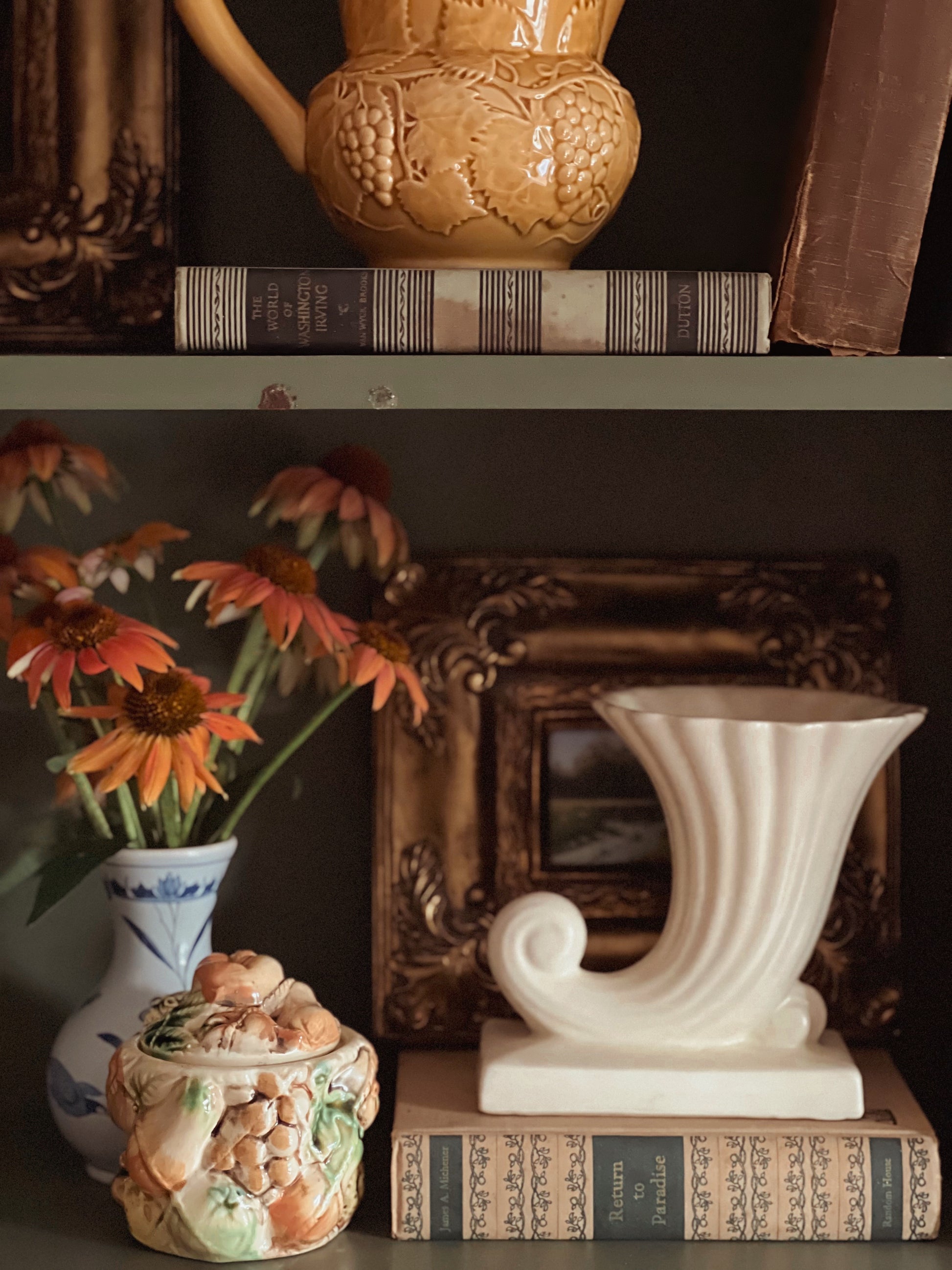 Decorative items including a teapot, books, and vases on a shelf.