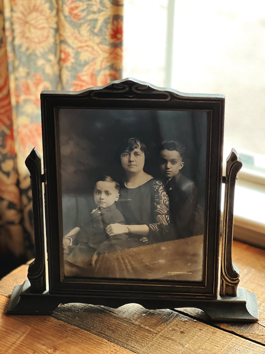 black and white family portrait in a vintage frame