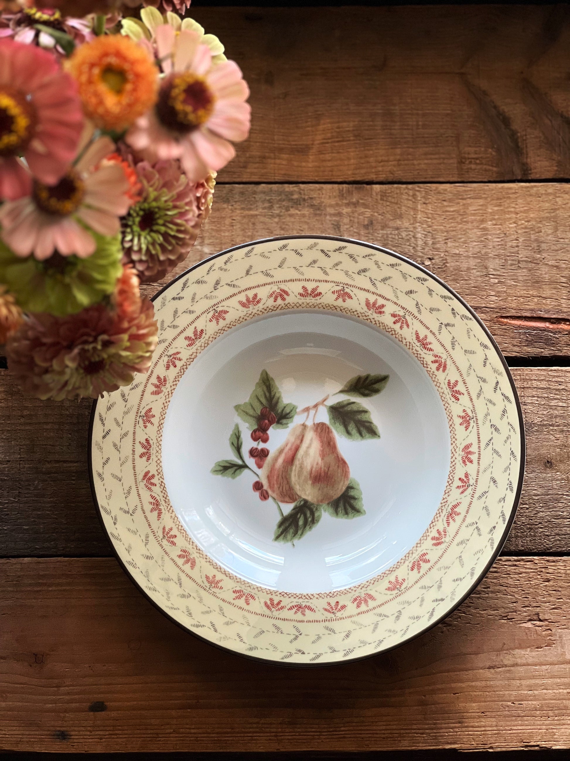 Vintage rimmed soup bowl with a fruit design  of pears and greenery