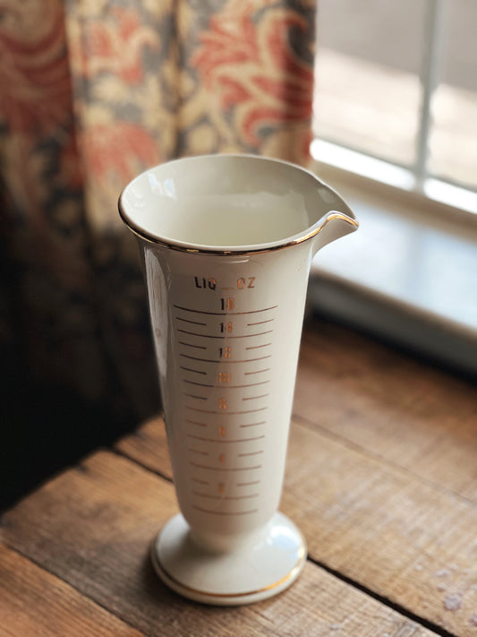 ivory and gold measuring beaker