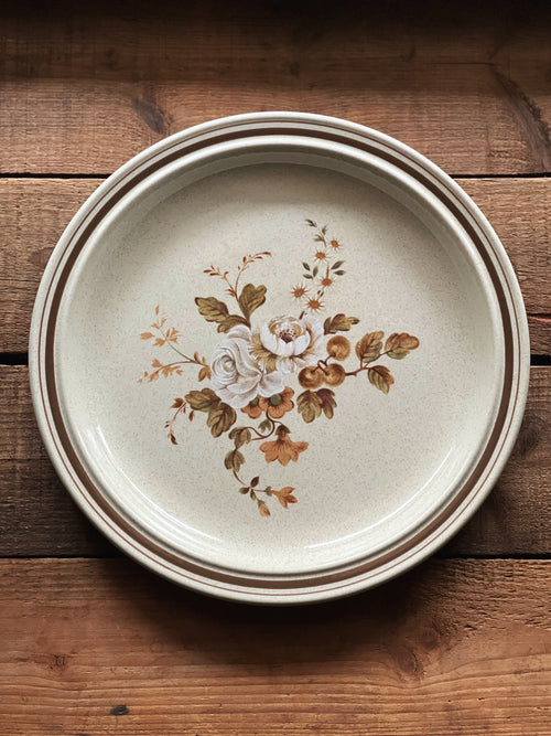 Ceramic plate with floral design on a wooden surface
