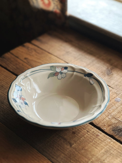 Ceramic bowl with floral patterns on a wooden surface