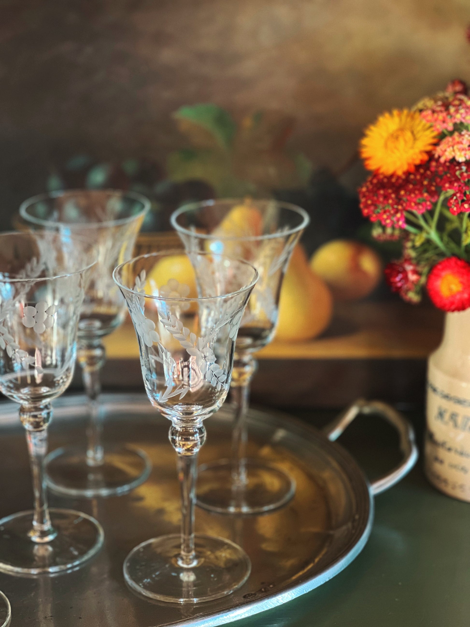 etched wine glasses on a silver tray 