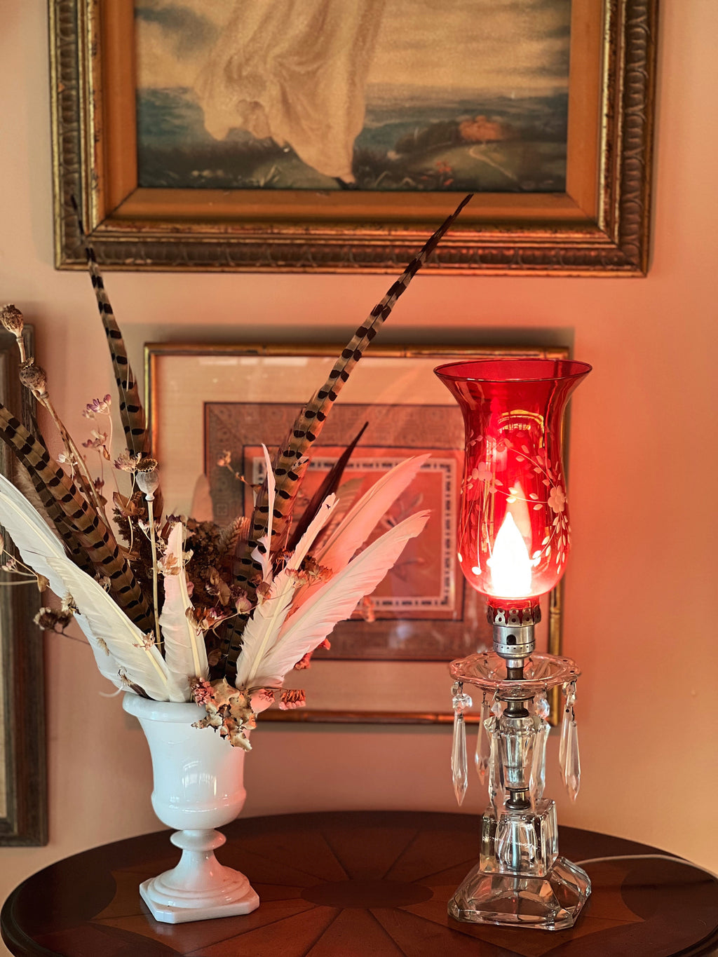 cranberry and crystal lamp on a table next to a dried floral arrangement
