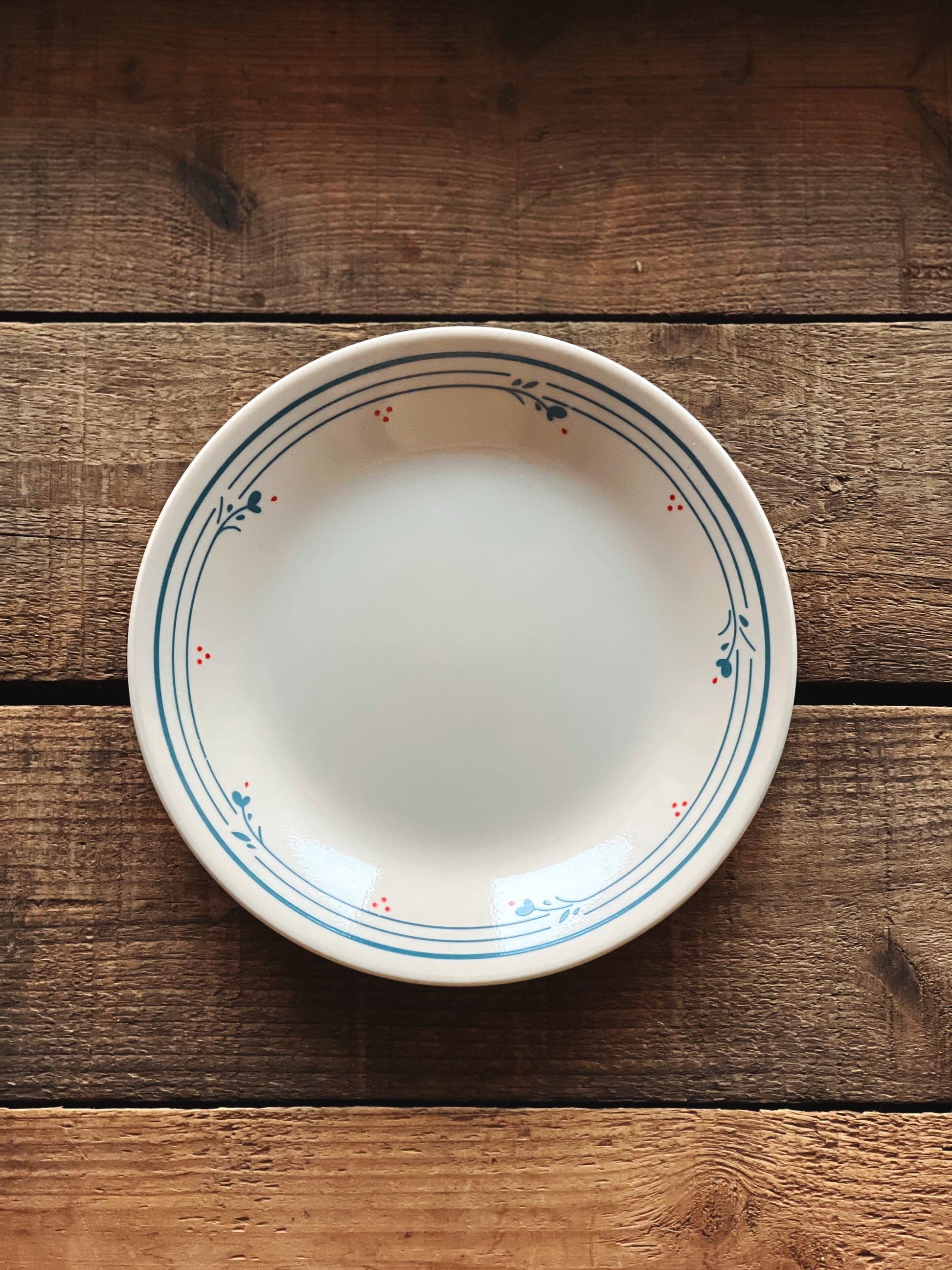White ceramic bowl with decorative rim on a wooden surface