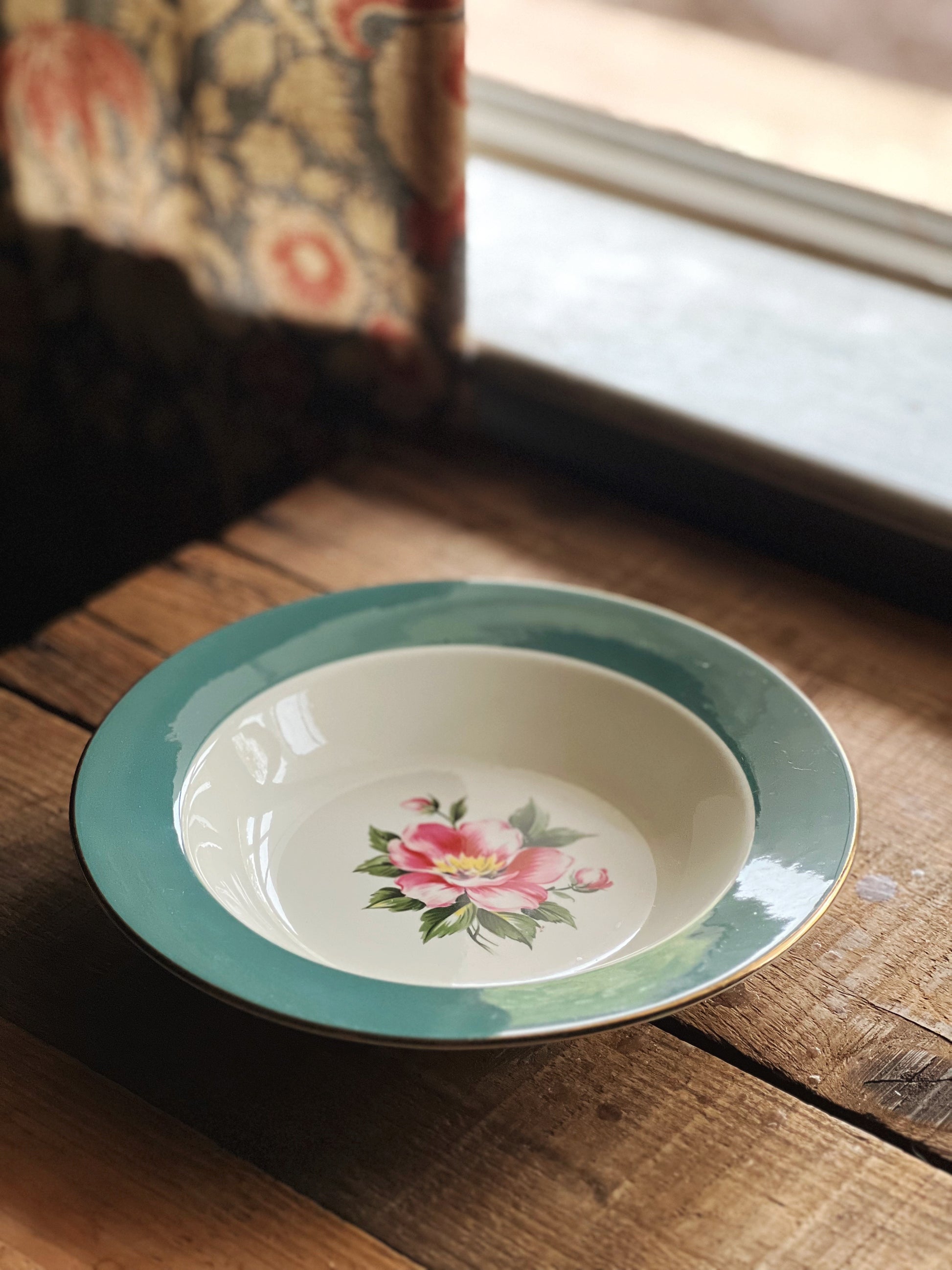 Ceramic bowl with floral design on a wooden surface