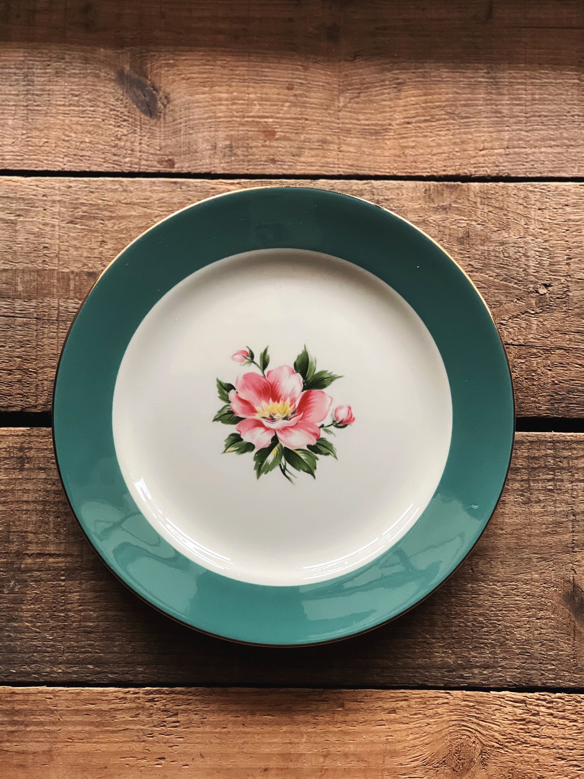 Plate with floral design on a wooden surface