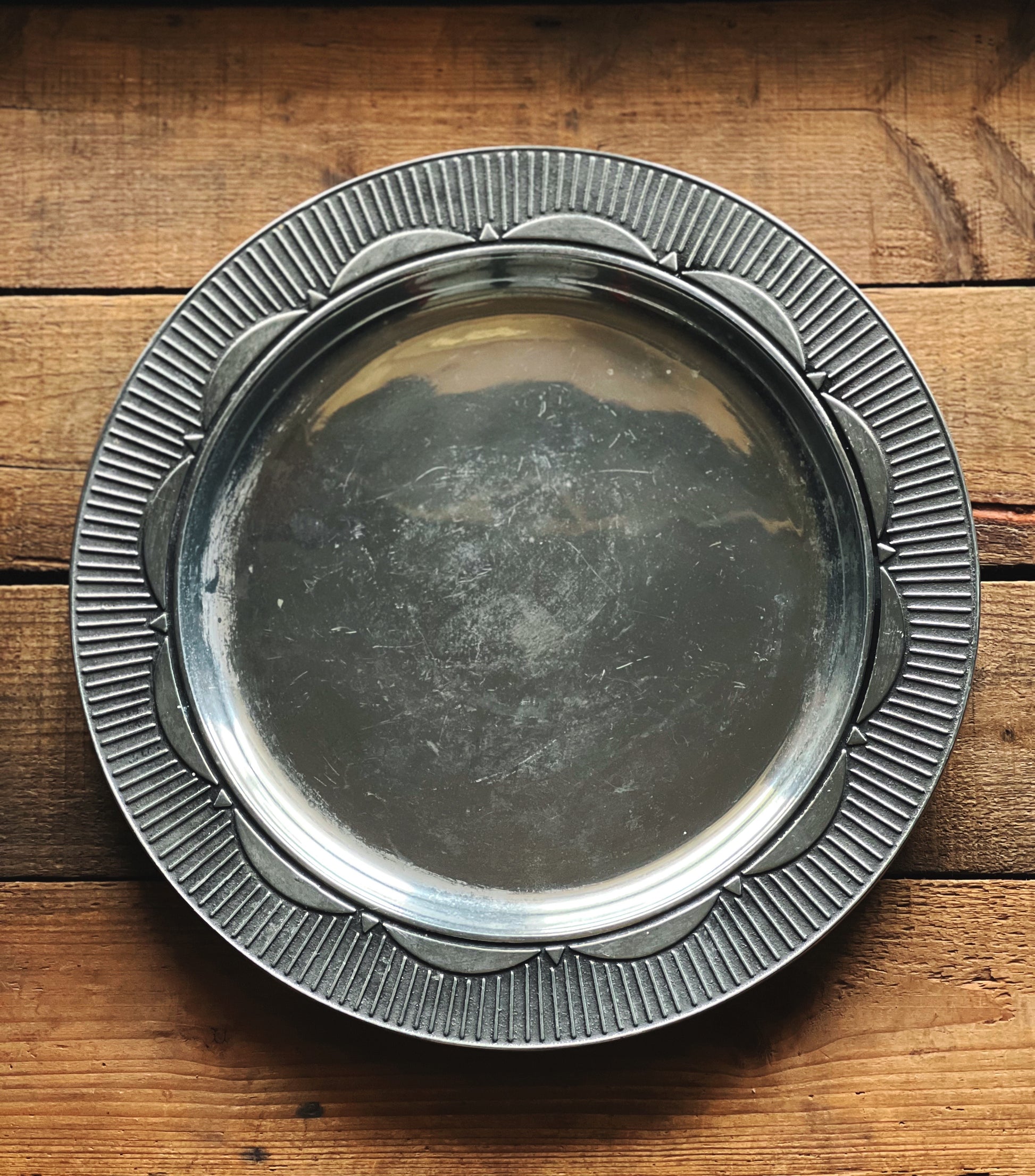 Silver metal tray on a wooden surface