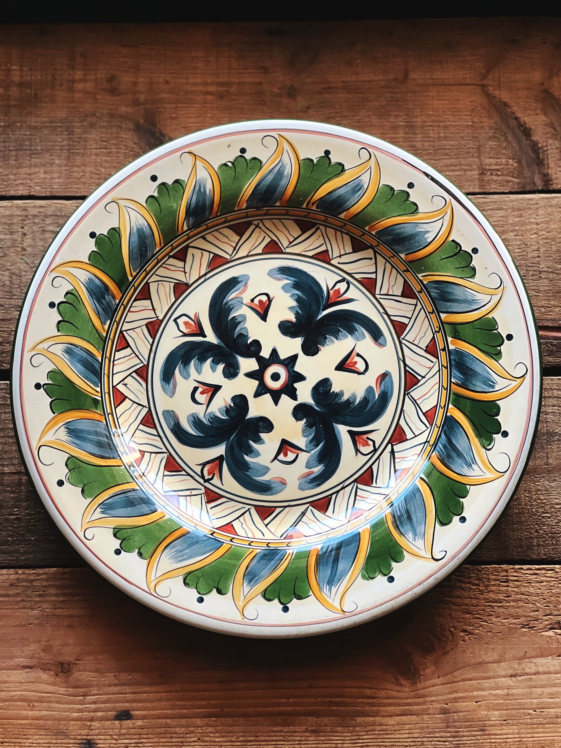 Decorative ceramic plate with intricate patterns on a wooden surface