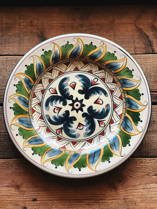 Decorative ceramic plate with intricate patterns on a wooden surface