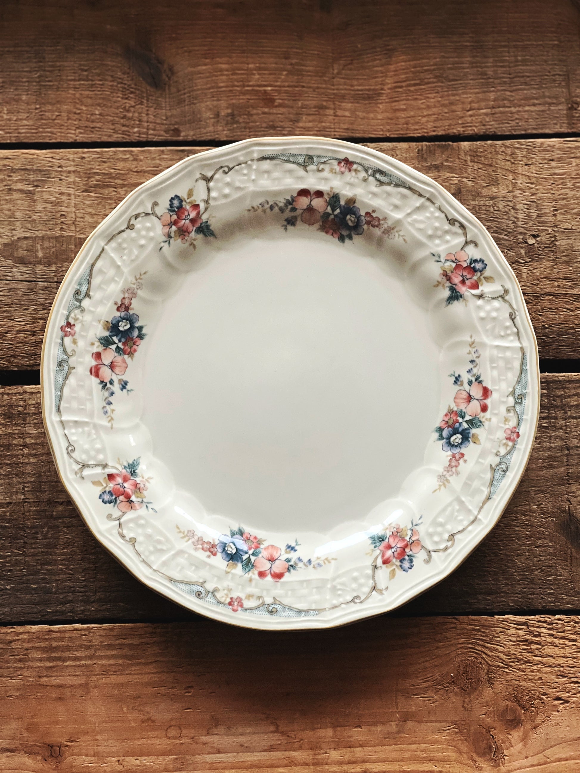 salad size plate with a floral and garland design rim