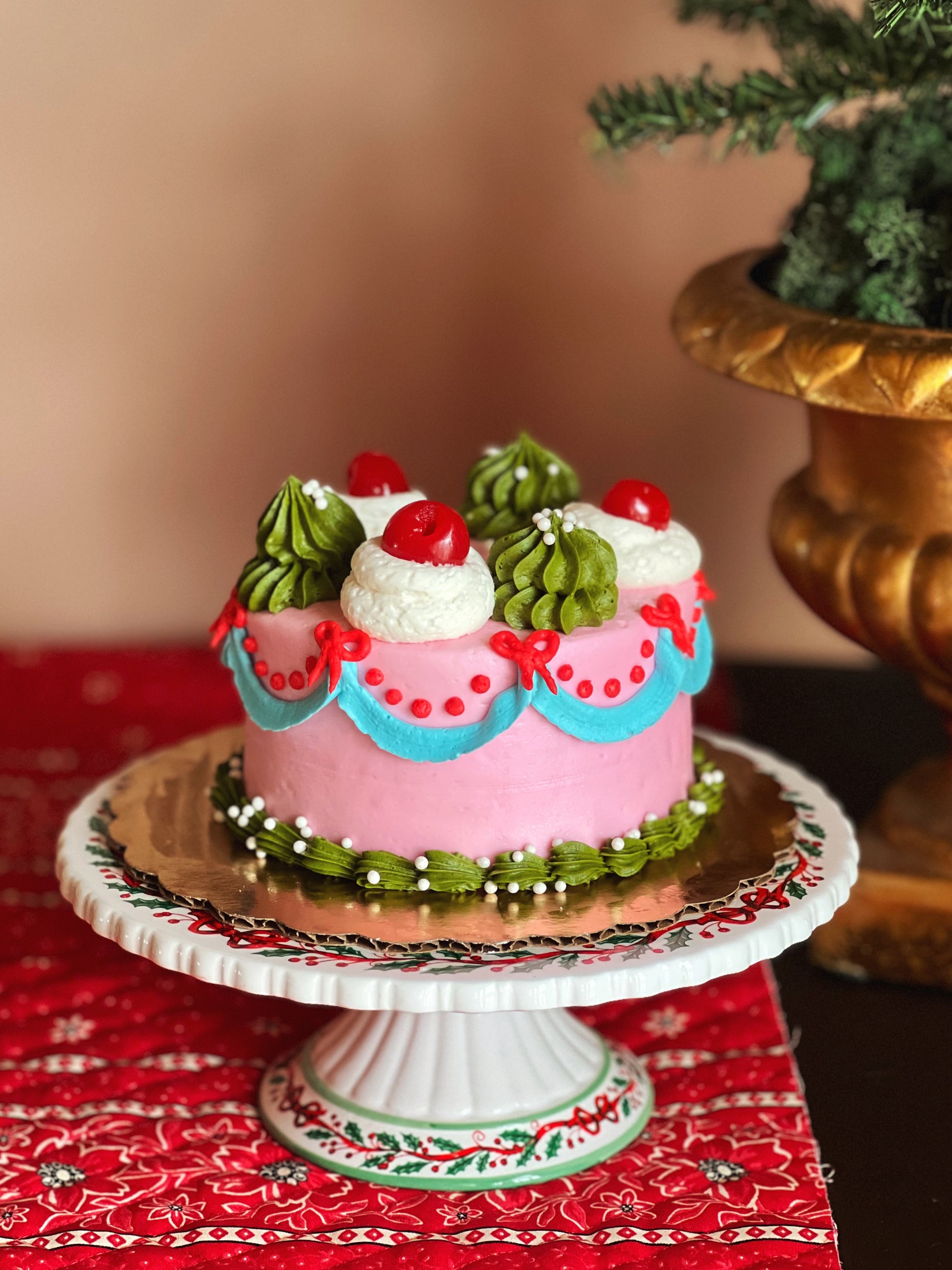 Decorative cake on a stand with a red and gold background
