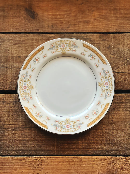 Decorative plate with floral patterns on a wooden surface