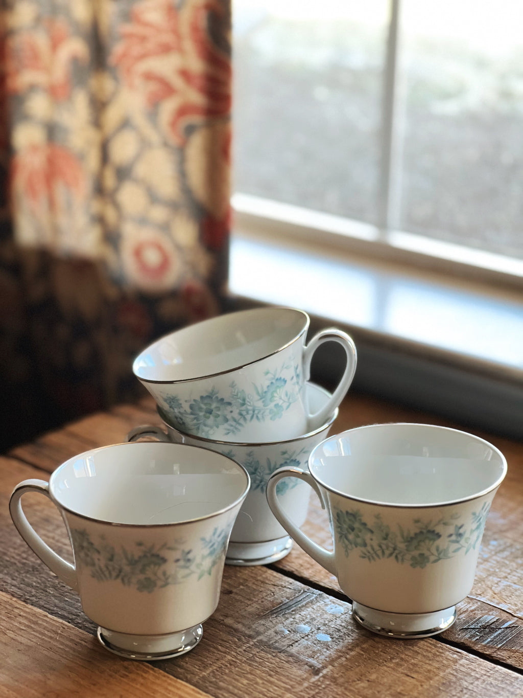 Noritake Milford teacup close-up showing blue floral design and platinum trim, vintage china