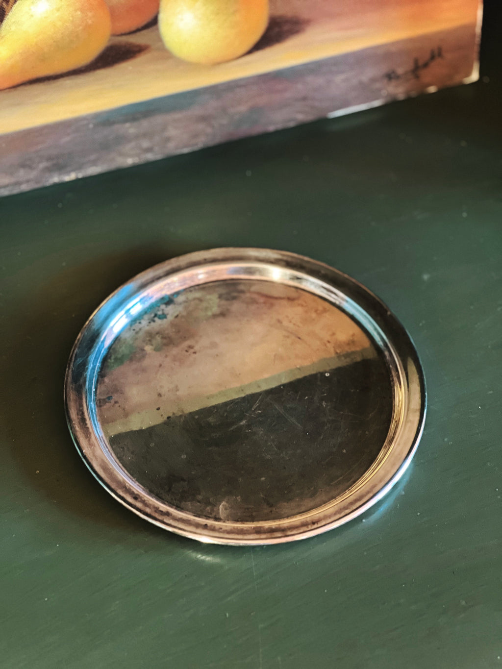 silver tray on a green surface with lemons in the background