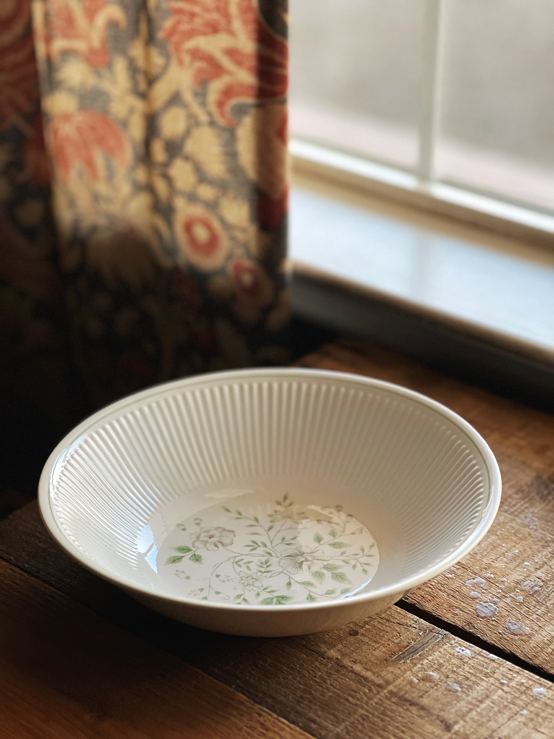 green floral design on an ivory bowl