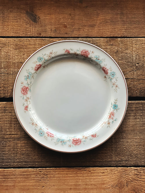 Decorative ceramic plate with floral patterns on a wooden surface