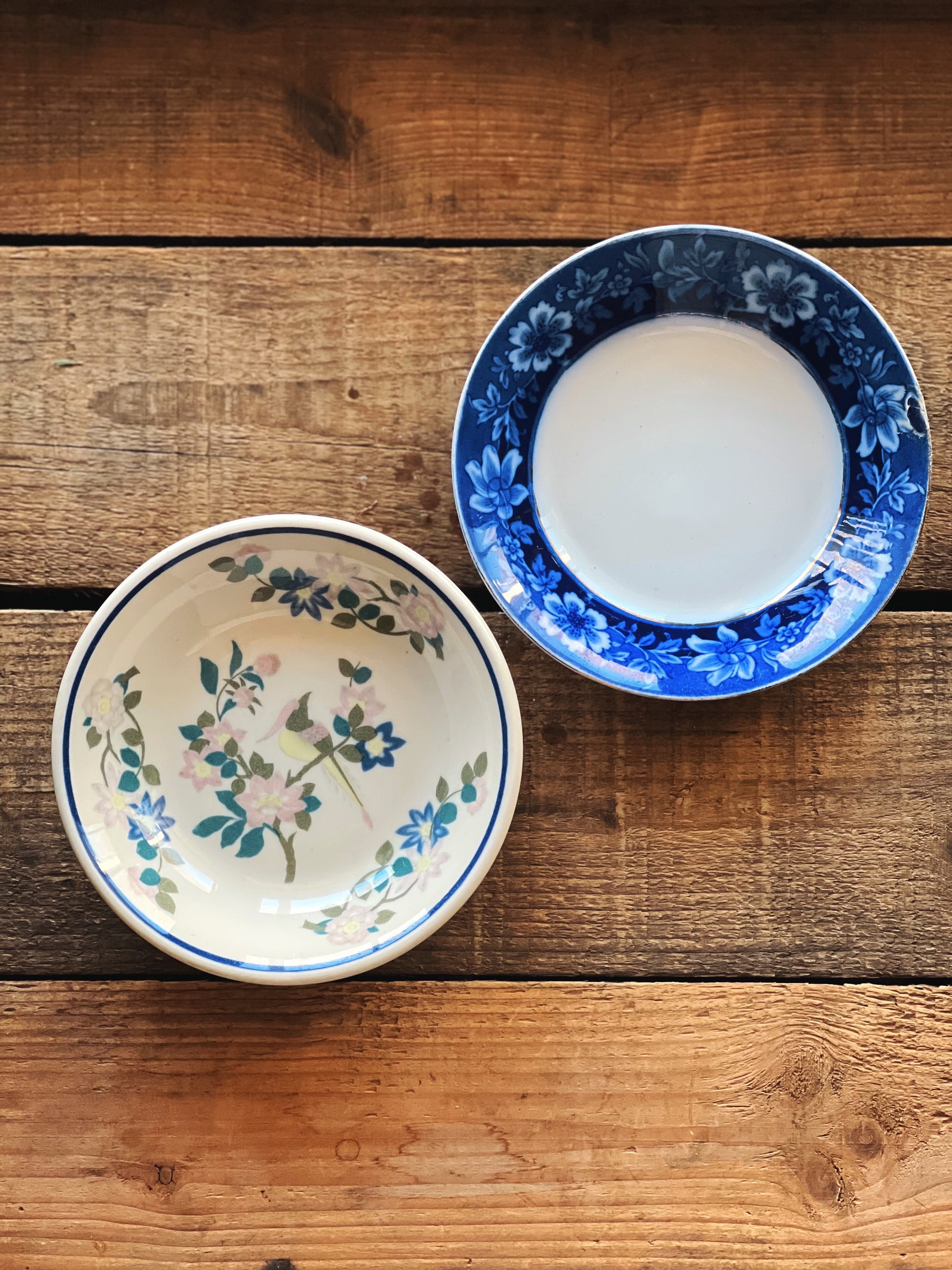 Two ceramic bowls with floral patterns on a wooden surface