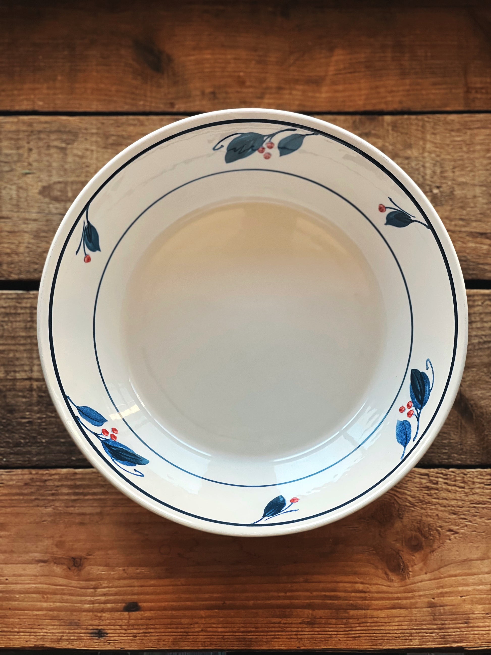 White ceramic bowl with decorative rim on a wooden surface