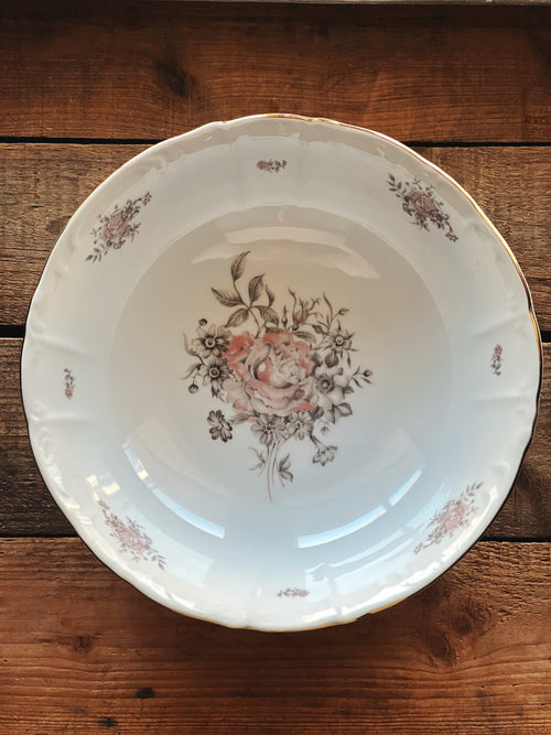 Floral-patterned ceramic plate on a wooden surface