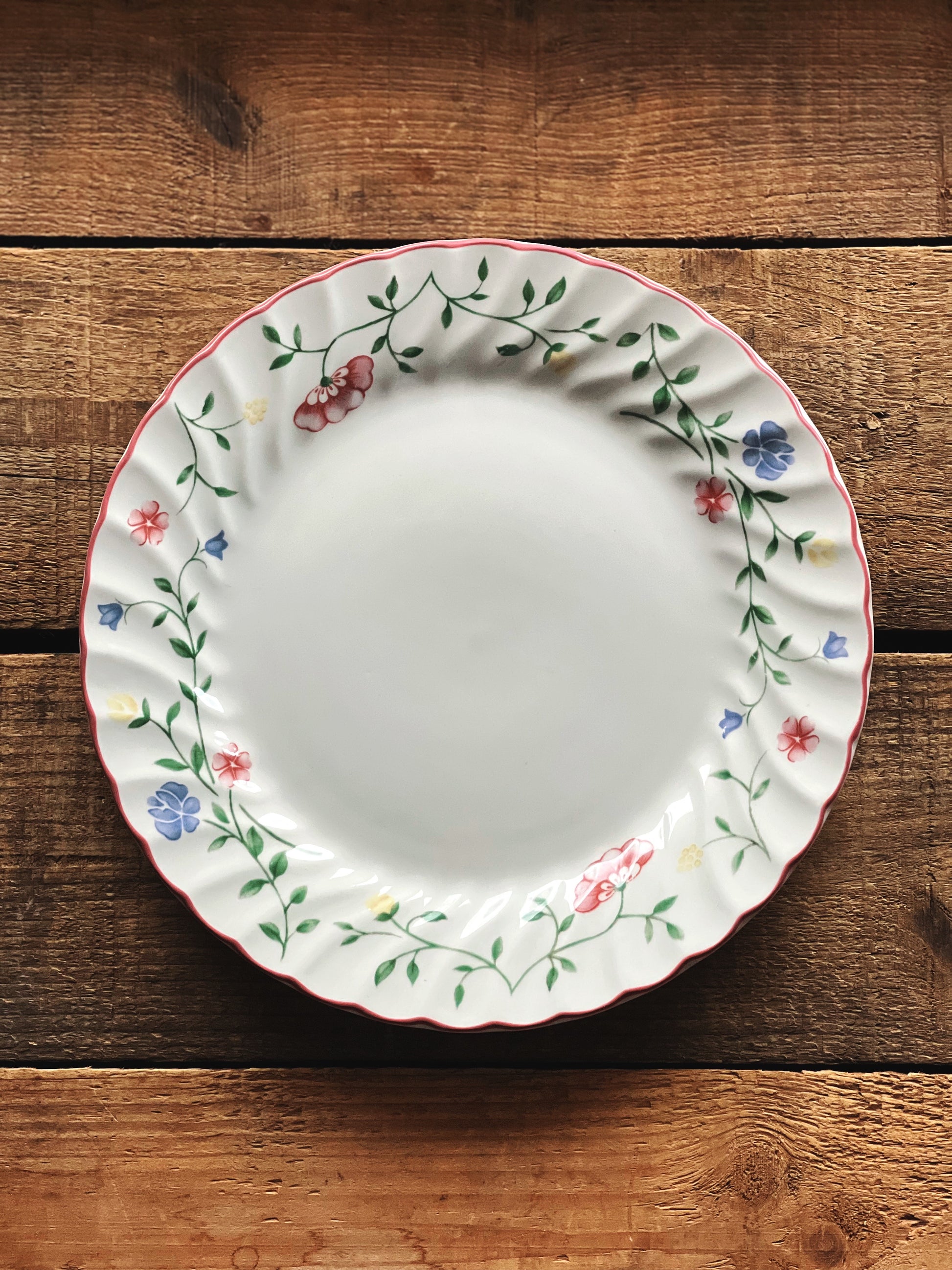 Decorative plate with floral patterns on a wooden surface