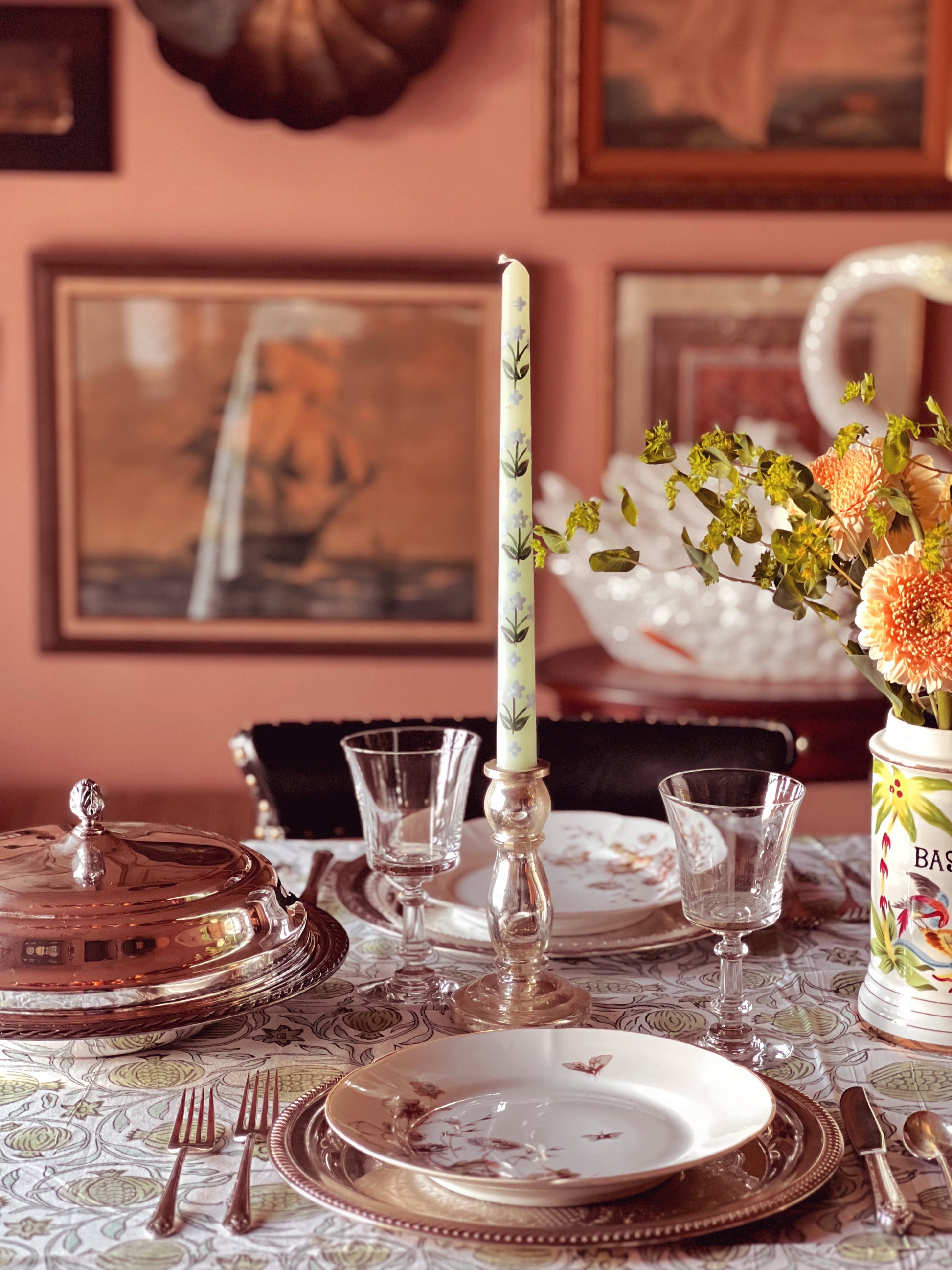 table set for a meal with silver serving pieces
