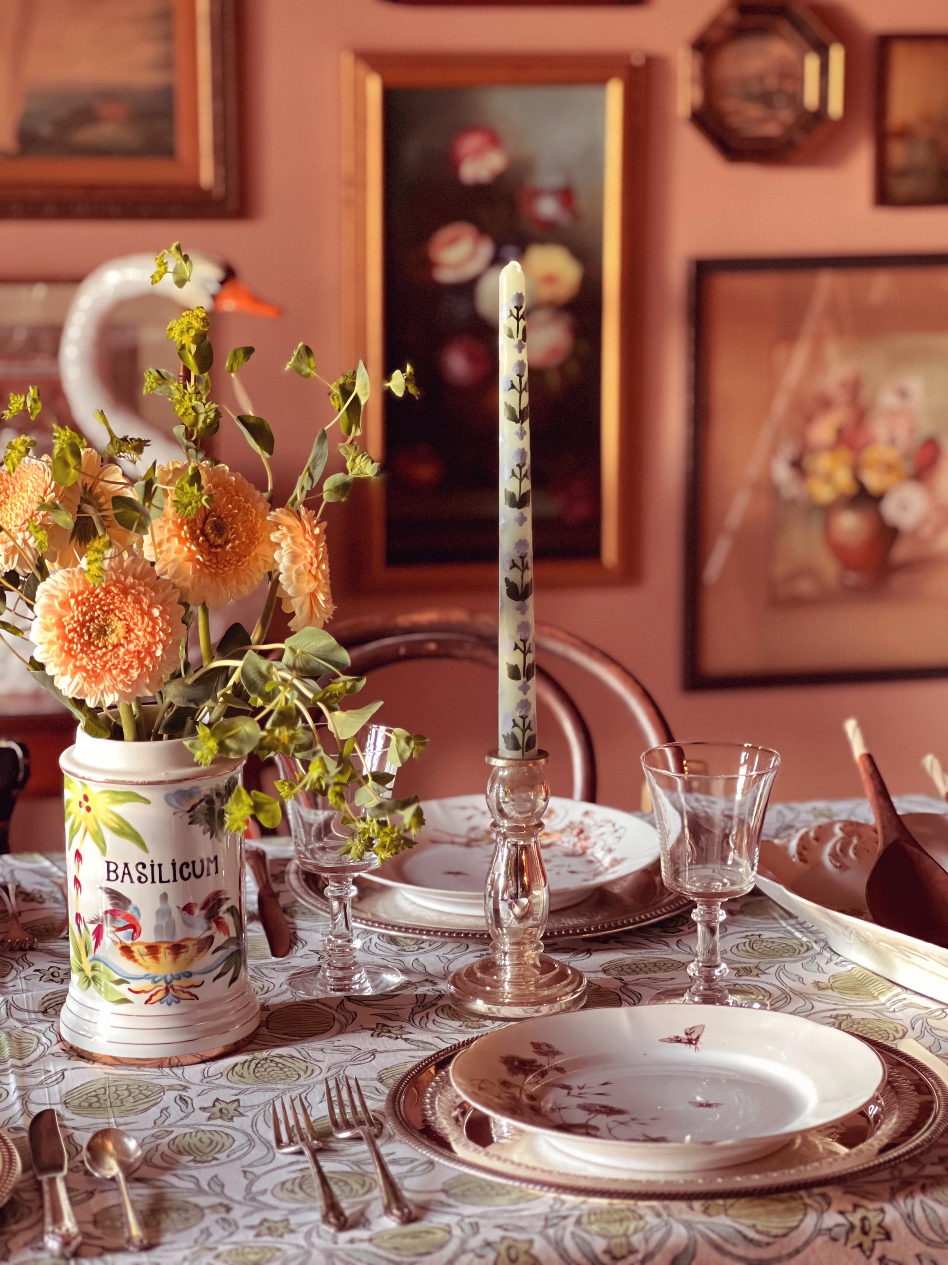 table set for a meal with artwork in the background