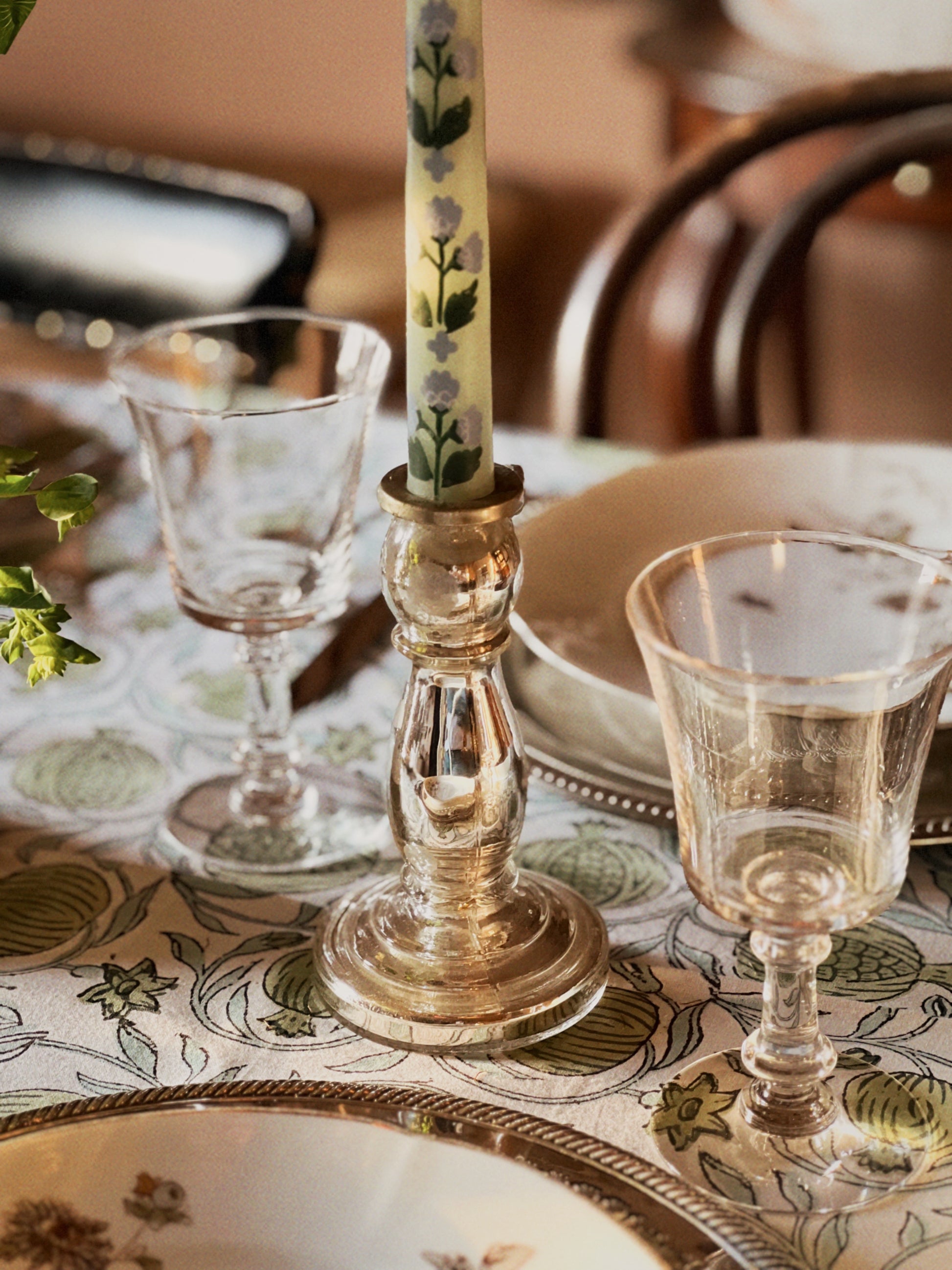 silver glass candleholder on a table set for a meal