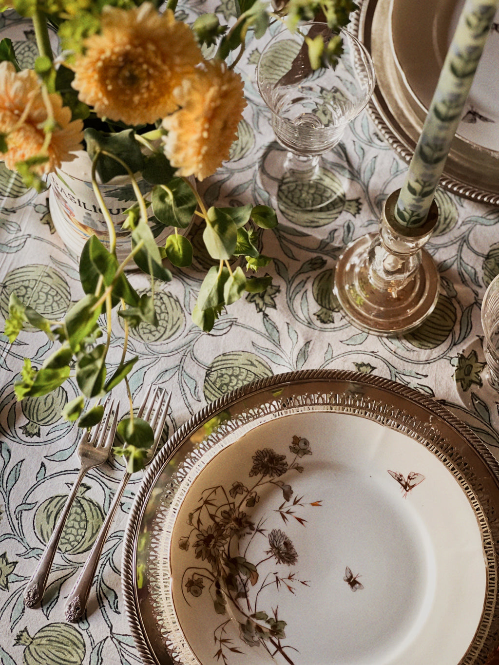 green white and blue block print tablecloth on a table set for a meal