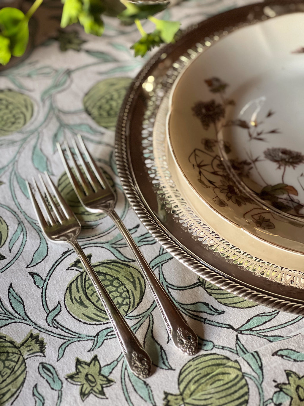 two forks on a table set for a meal