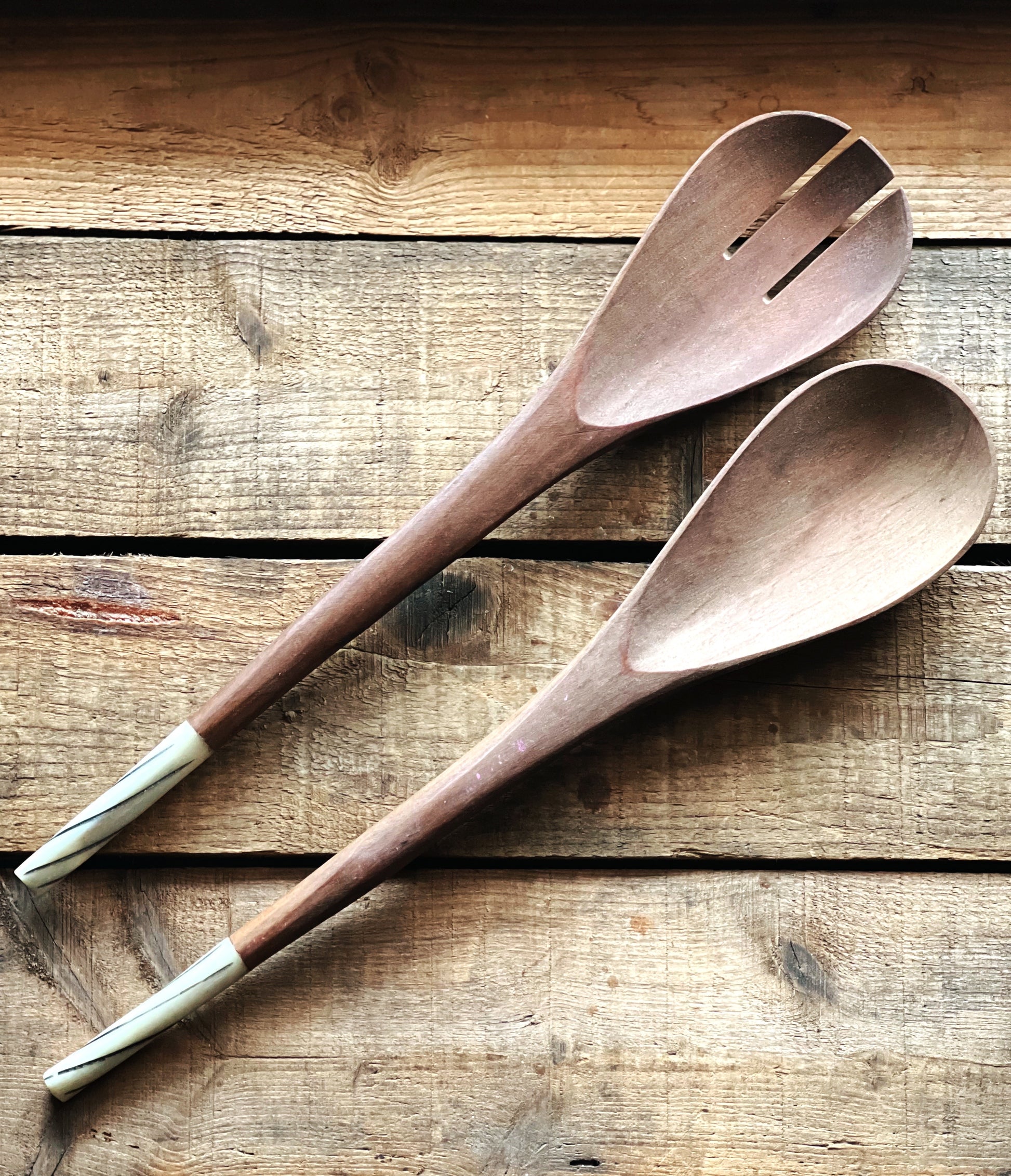 pair of wooden salad servers with a bone handle