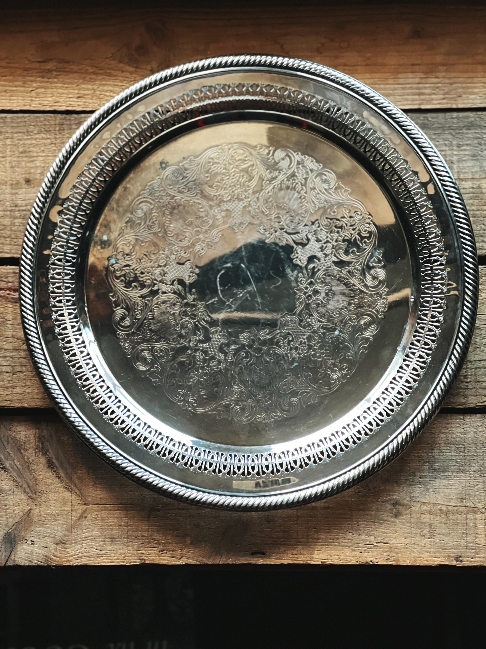 Silver decorative tray on a wooden surface