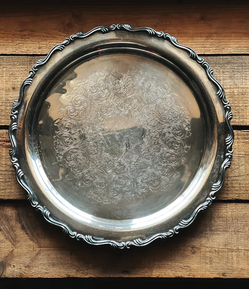 Silver decorative tray on a wooden surface