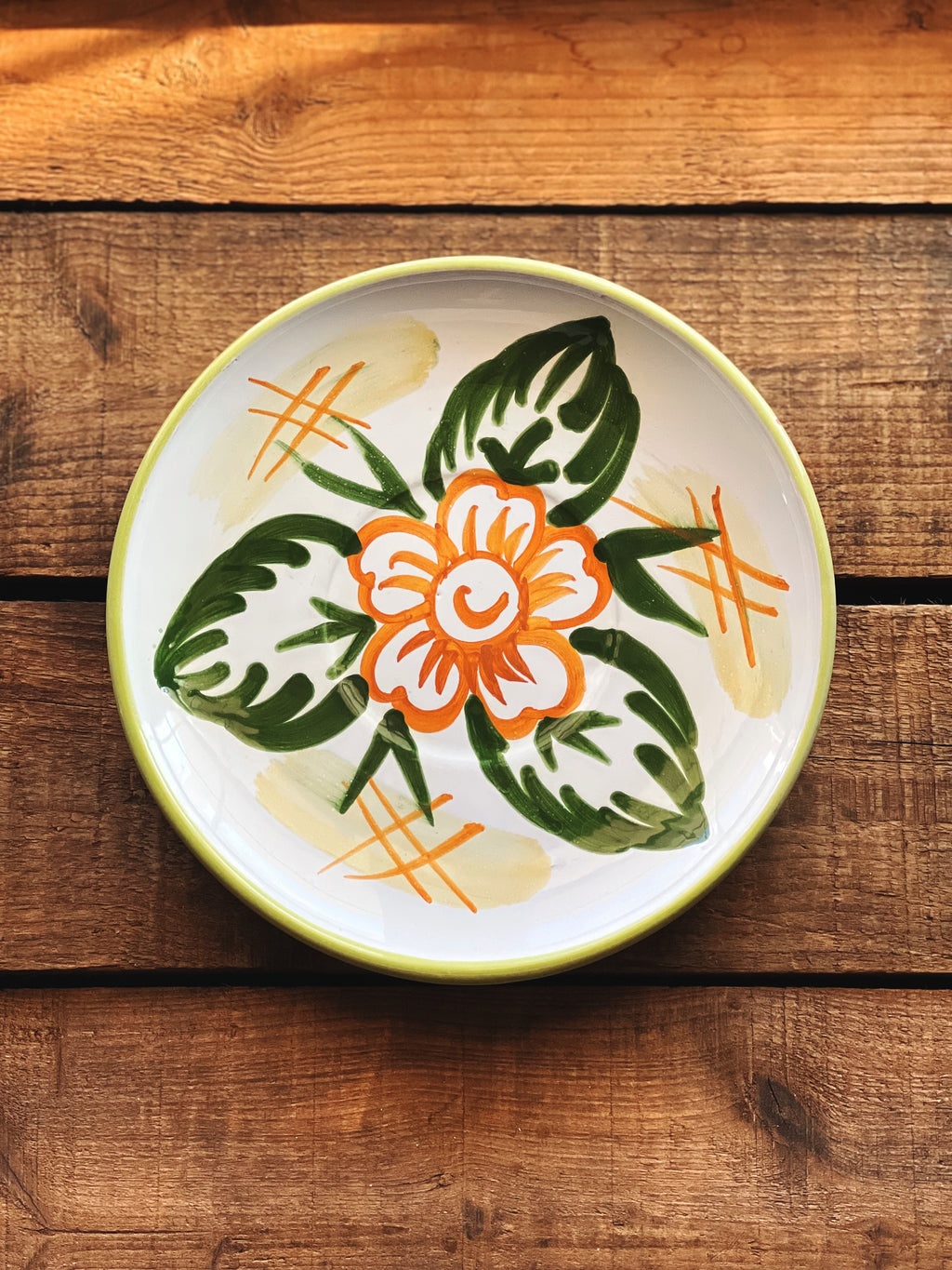 Ceramic plate with floral design on a wooden surface