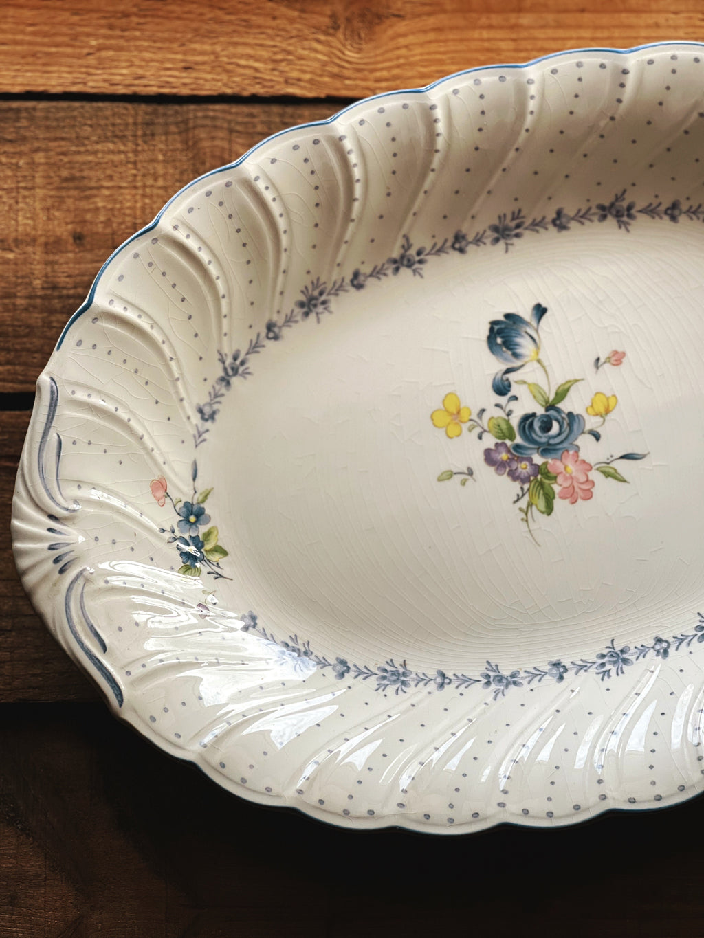 Decorative ceramic platter with floral design on a wooden surface