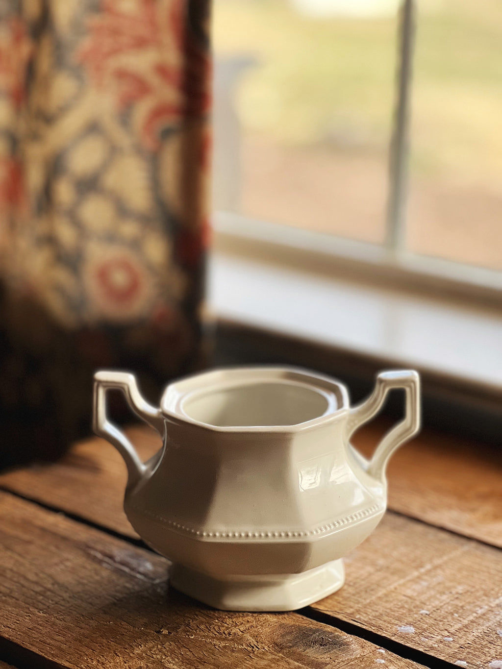 white sugar bowl on a wood surface