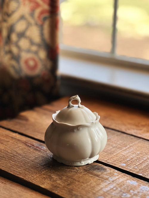 small white ironstone sugar bowl on a wood surface